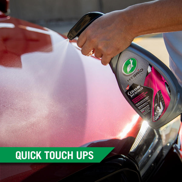 The fine mist of Ceramic 3-in-1 Detailer is sprayed onto the surface of a car. 