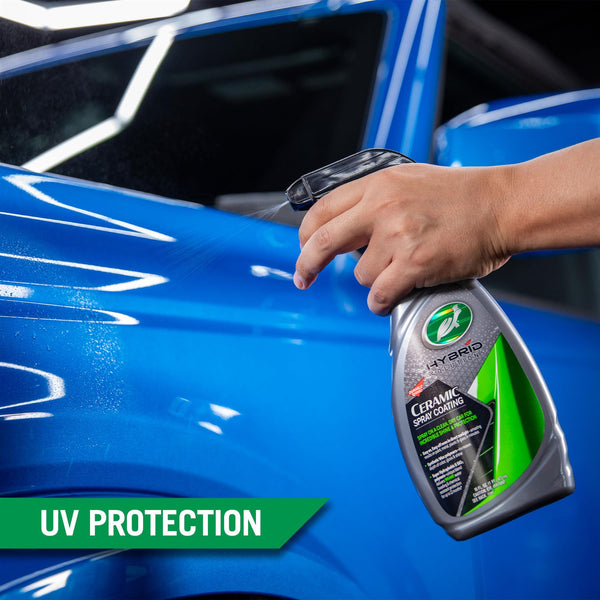 The fine mist of Ceramic Spray Coating is sprayed onto the surface of a blue car. 