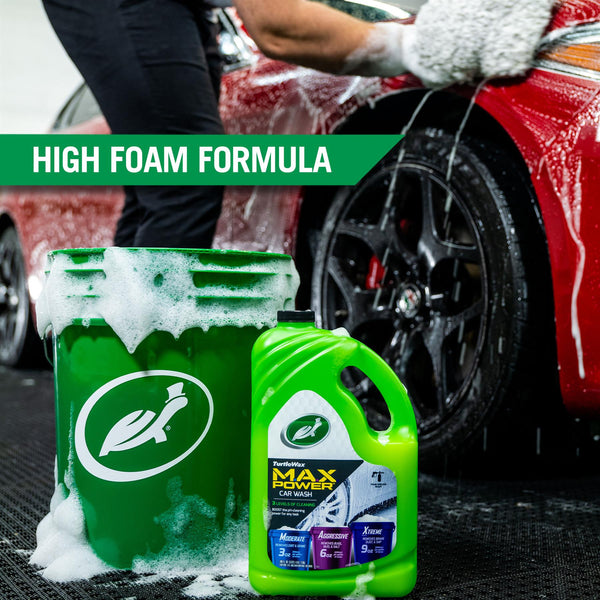 MAX Power is displayed next to a soapy green 5 gallon bucket. The products are set against a backdrop of a person using a wash mitt to scrub the surface of a red car. 