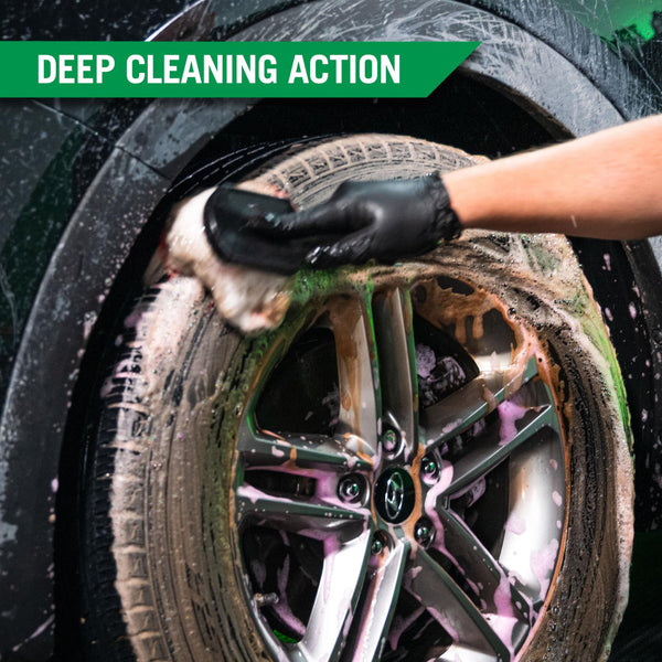 A person using the kits tire brush to scrub off dirt and grime from the tires surface. 